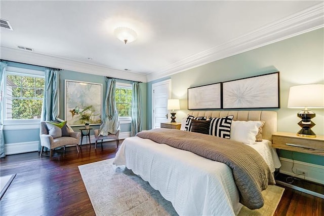 bedroom featuring crown molding and dark wood-type flooring