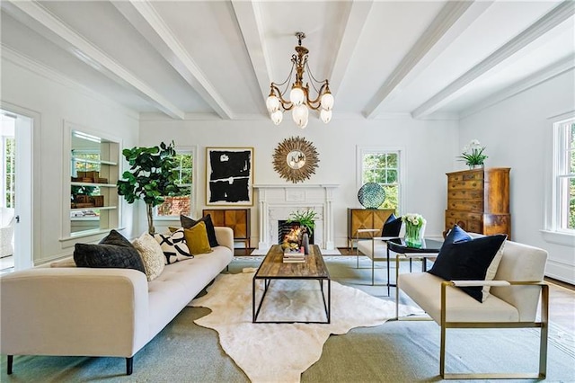 living room featuring beam ceiling, a wealth of natural light, and a chandelier