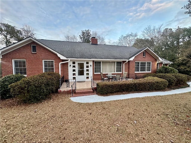 ranch-style house with a front lawn and a patio