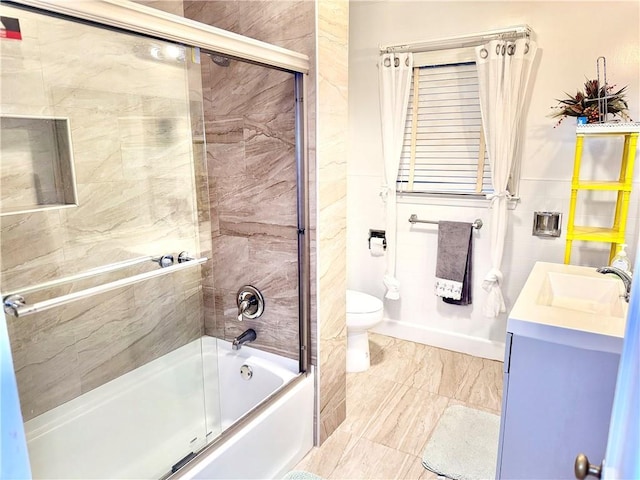 full bathroom with vanity, combined bath / shower with glass door, and toilet