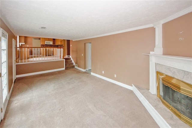 4161 Windermere Dr, Lithonia, GA 30038 - unfurnished living room with a high end fireplace, stairs, a textured ceiling, crown molding, and light carpet