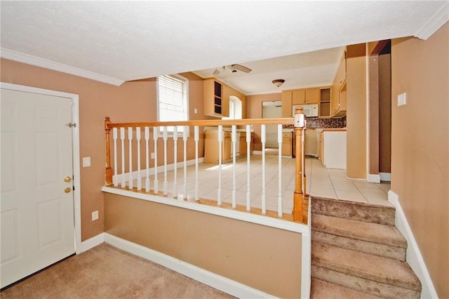 4161 Windermere Dr, Lithonia, GA 30038 - entrance foyer featuring light carpet, a textured ceiling, crown molding, baseboards, and stairs