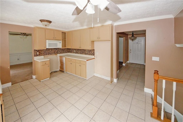 4161 Windermere Dr, Lithonia, GA 30038 - kitchen featuring ornamental molding, cream cabinets, decorative backsplash, white microwave, and ceiling fan