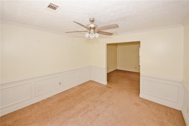 4161 Windermere Dr, Lithonia, GA 30038 - spare room with visible vents, light colored carpet, ornamental molding, a textured ceiling, and a ceiling fan