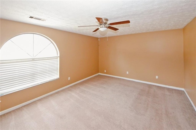4161 Windermere Dr, Lithonia, GA 30038 - unfurnished room with visible vents, a healthy amount of sunlight, a textured ceiling, and carpet floors