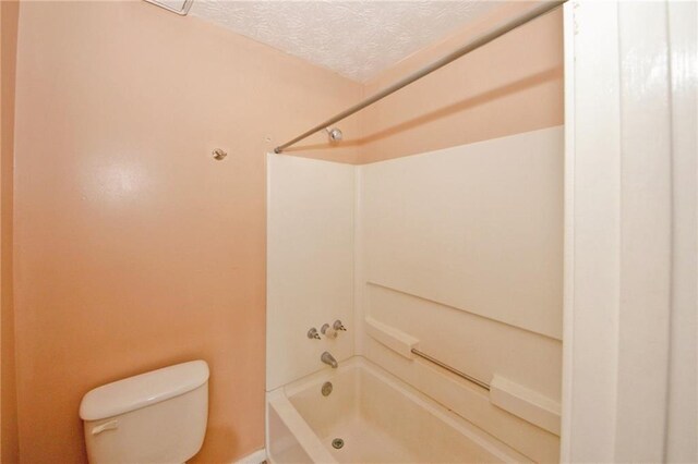 4161 Windermere Dr, Lithonia, GA 30038 - bathroom featuring toilet, a textured ceiling, and  shower combination