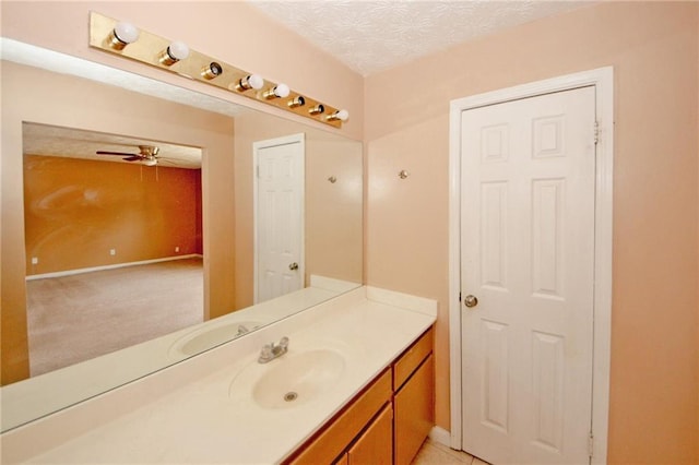 4161 Windermere Dr, Lithonia, GA 30038 - bathroom with ceiling fan, vanity, baseboards, and a textured ceiling