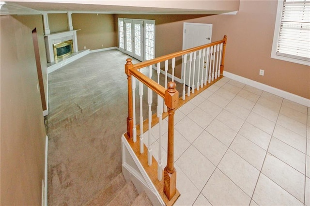 4161 Windermere Dr, Lithonia, GA 30038 - stairway with tile patterned floors, french doors, baseboards, and a glass covered fireplace