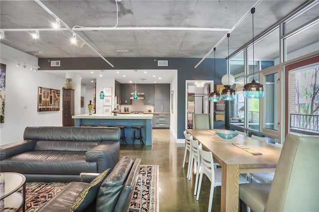 845 Spring St NW Unit 129, Atlanta, GA 30308 - dining area featuring concrete floors, baseboards, and rail lighting