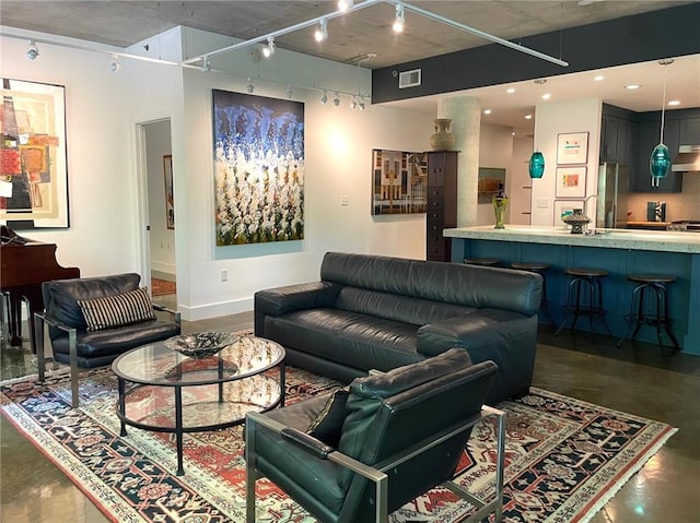 845 Spring St NW Unit 129, Atlanta, GA 30308 - living room with track lighting, finished concrete flooring, and baseboards