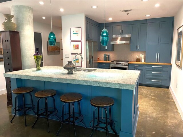 845 Spring St NW Unit 129, Atlanta, GA 30308 - kitchen featuring appliances with stainless steel finishes, concrete floors, a sink, under cabinet range hood, and blue cabinetry