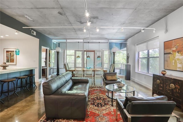 845 Spring St NW Unit 129, Atlanta, GA 30308 - living area featuring baseboards, finished concrete flooring, and plenty of natural light