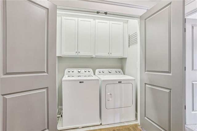 laundry area featuring cabinets and washer and clothes dryer