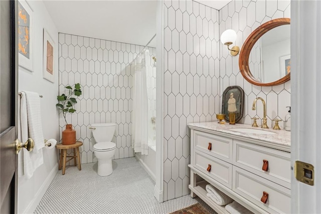 full bathroom with shower / tub combo with curtain, vanity, tile patterned flooring, and tile walls