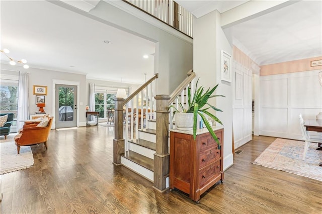 staircase with wood-type flooring and a chandelier