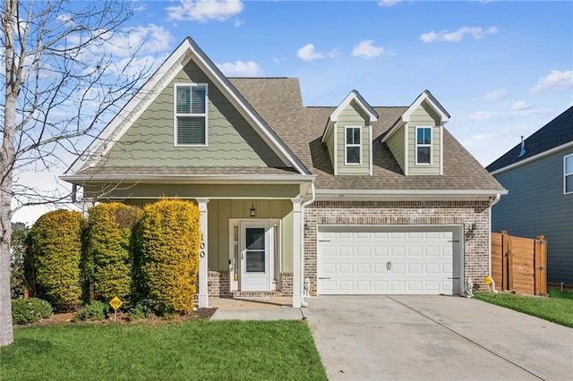 view of front of house featuring a garage and a front lawn