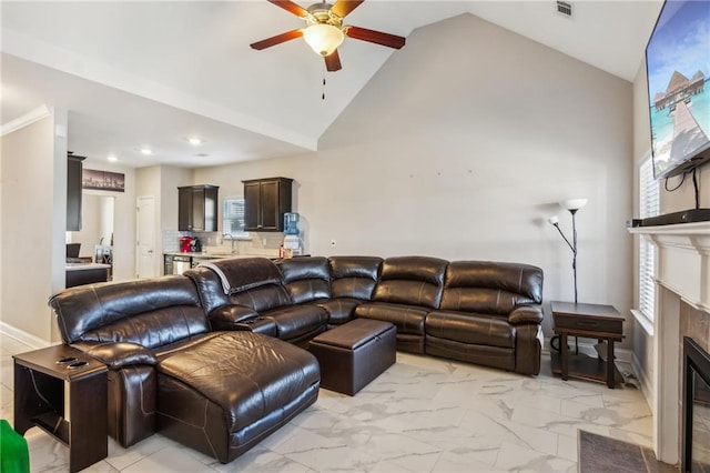 living room featuring ceiling fan, high vaulted ceiling, and sink