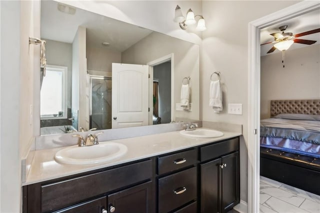 bathroom with a shower with door, vanity, and ceiling fan