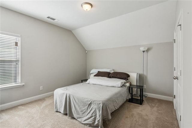 bedroom featuring lofted ceiling and light colored carpet