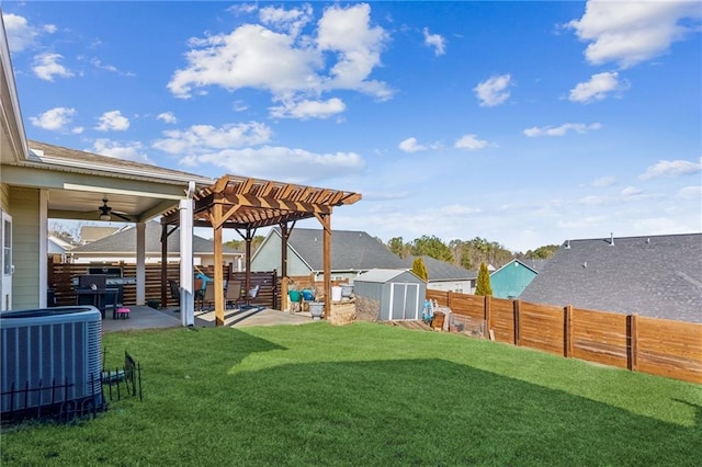 view of yard featuring a patio area, a pergola, cooling unit, ceiling fan, and a storage unit