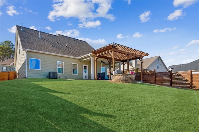 back of property featuring ceiling fan, a pergola, a lawn, and central air condition unit