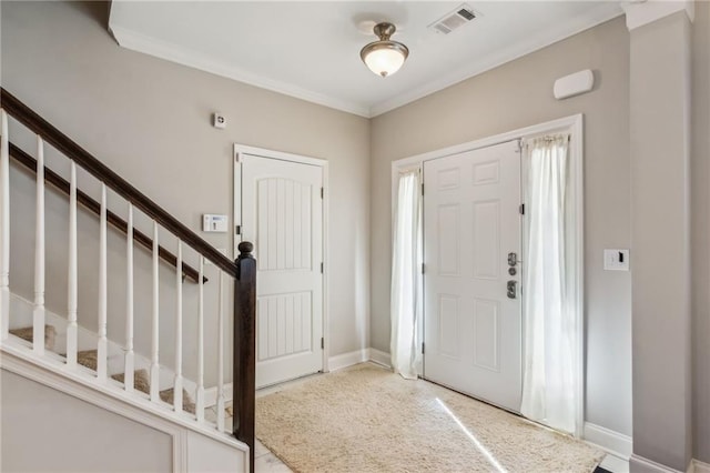 entryway featuring crown molding