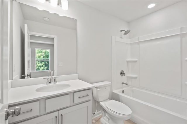 full bathroom featuring vanity, bathing tub / shower combination, and toilet