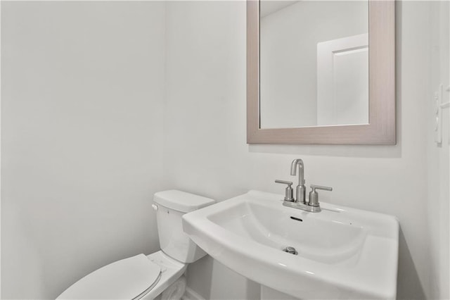 bathroom featuring sink and toilet