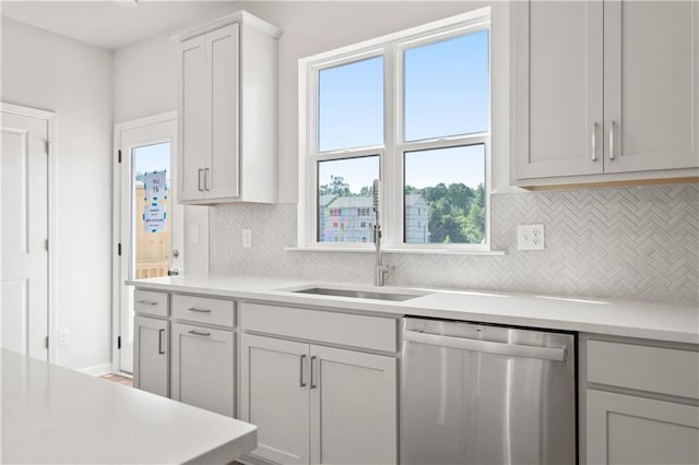 kitchen featuring plenty of natural light, decorative backsplash, sink, and dishwasher