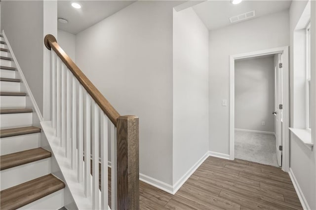 stairway featuring hardwood / wood-style floors