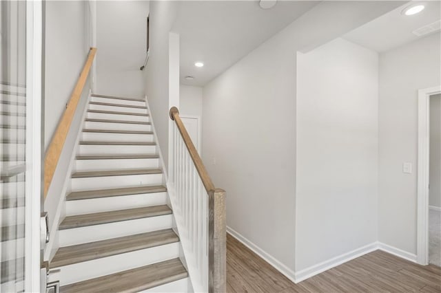 staircase featuring hardwood / wood-style floors