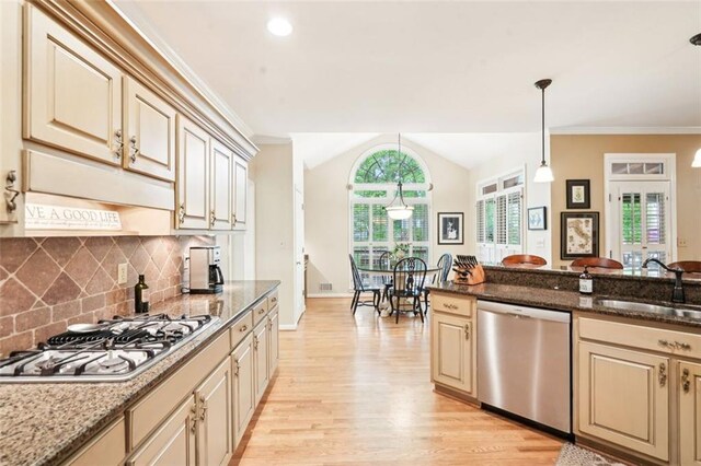 kitchen with light wood-type flooring, a sink, appliances with stainless steel finishes, and cream cabinets