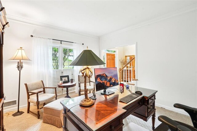 office area featuring light carpet, baseboards, and crown molding