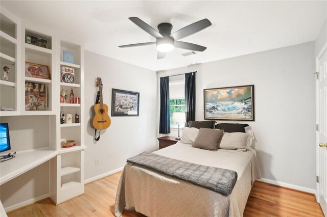 bedroom featuring light wood-style floors, baseboards, and ceiling fan