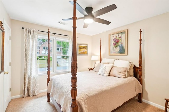 carpeted bedroom featuring ceiling fan, baseboards, and visible vents
