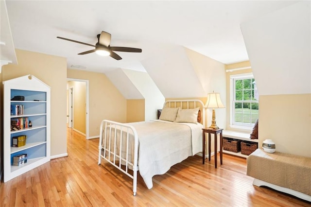 bedroom with vaulted ceiling, a ceiling fan, light wood-type flooring, baseboards, and visible vents