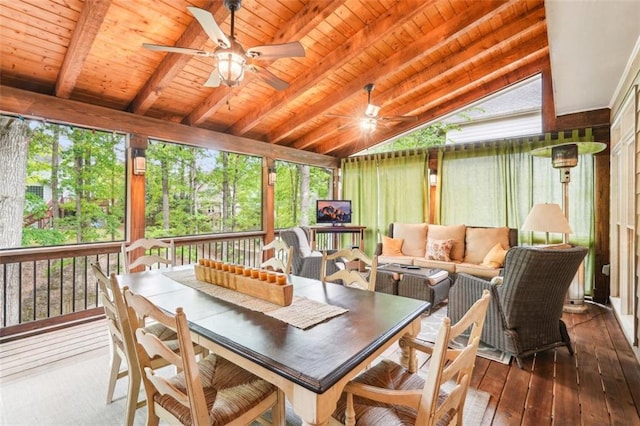sunroom / solarium featuring hardwood / wood-style floors, an outdoor hangout area, a ceiling fan, and lofted ceiling with beams