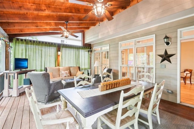 sunroom / solarium featuring lofted ceiling with beams, outdoor lounge area, hardwood / wood-style flooring, and ceiling fan