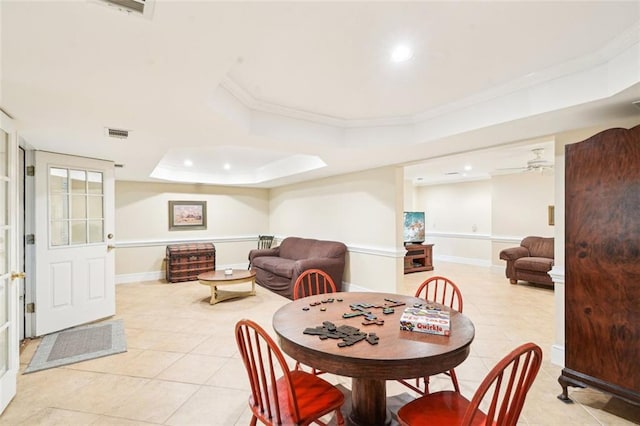 dining space with a tray ceiling, light tile patterned flooring, baseboards, recessed lighting, and ornamental molding