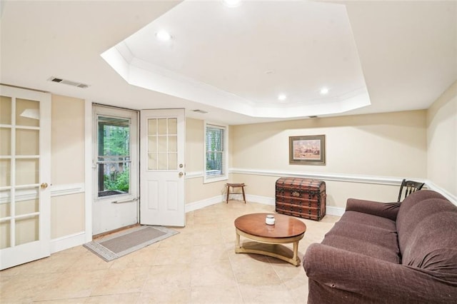 living area with crown molding, light tile patterned flooring, a raised ceiling, visible vents, and recessed lighting