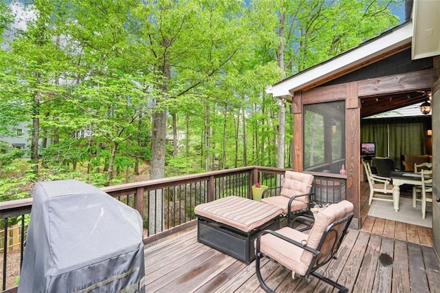deck featuring a sunroom and area for grilling