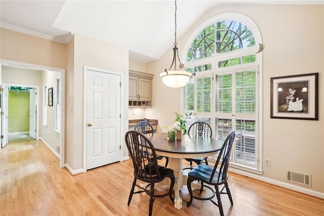 dining area featuring lofted ceiling, visible vents, light wood finished floors, and baseboards