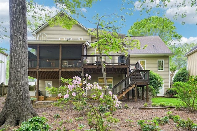 rear view of house featuring a wooden deck, a sunroom, and stairs