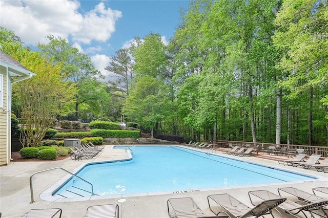 pool featuring fence and a patio area