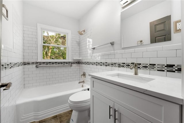 bathroom featuring tile walls, shower / bath combination, toilet, vanity, and tile patterned flooring