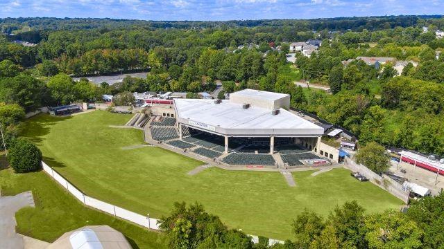 drone / aerial view featuring a wooded view