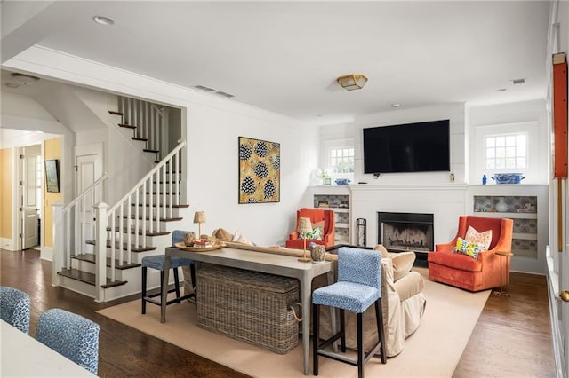 living room with hardwood / wood-style floors and a healthy amount of sunlight