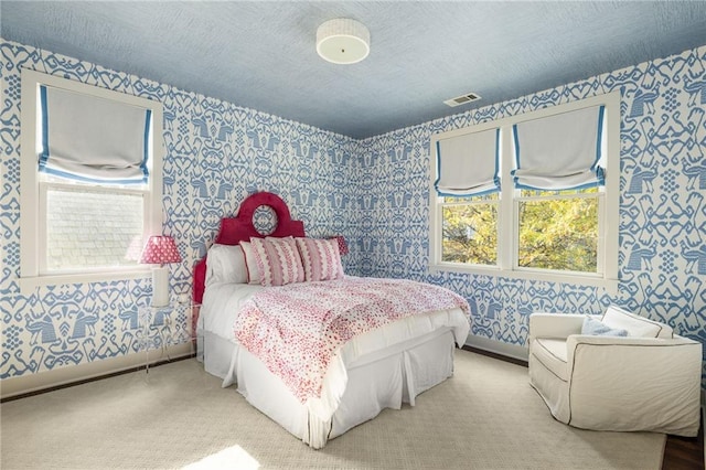 bedroom featuring carpet and a textured ceiling