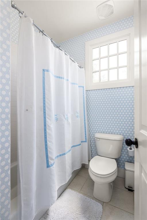 bathroom with tile patterned floors and toilet