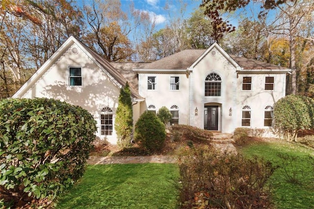 view of front facade featuring french doors and a front lawn